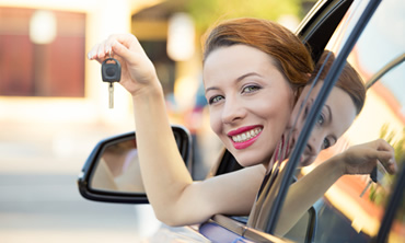 Woman in new car with keys