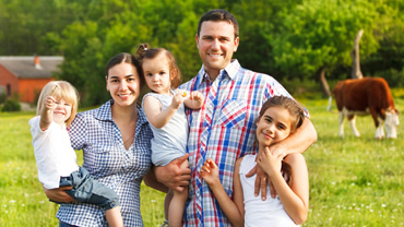 Family of four on farm.