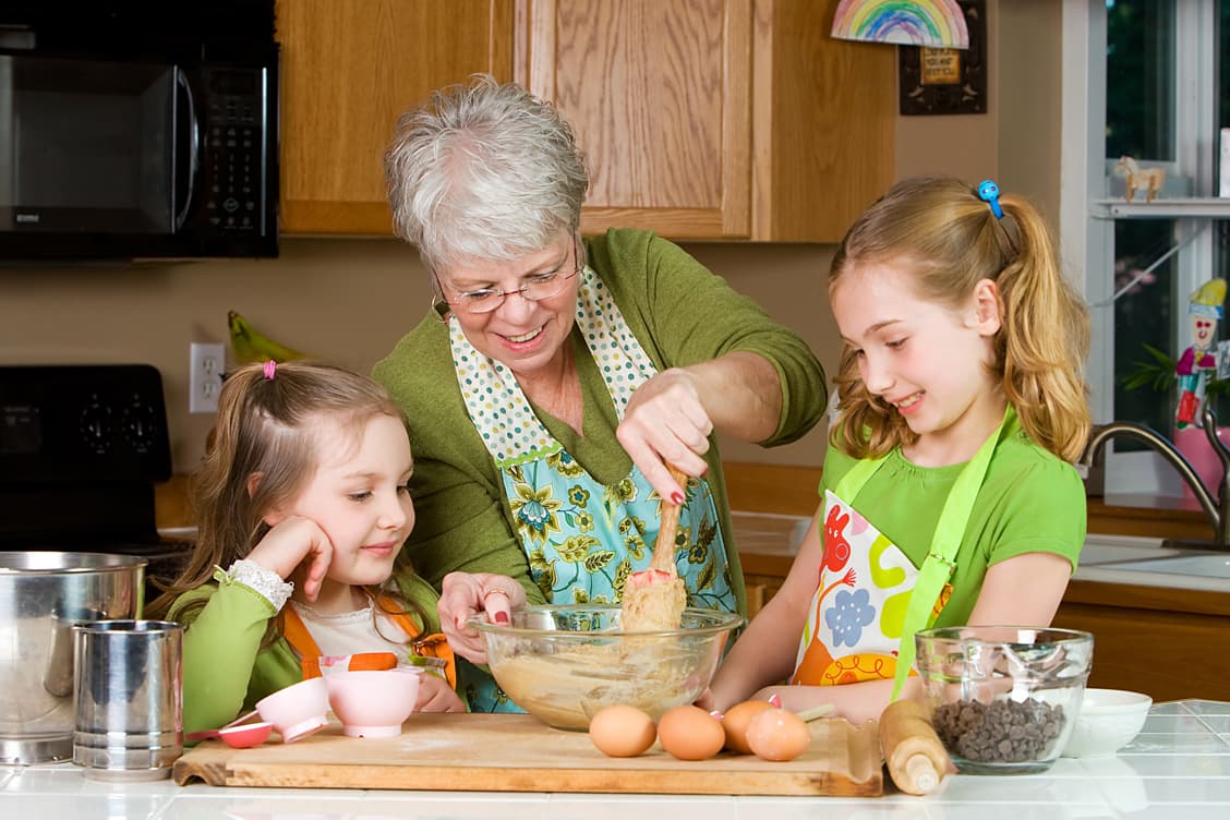 Grandmother baking cookies with granddaughters