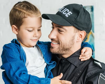 Police officer hugging his kid